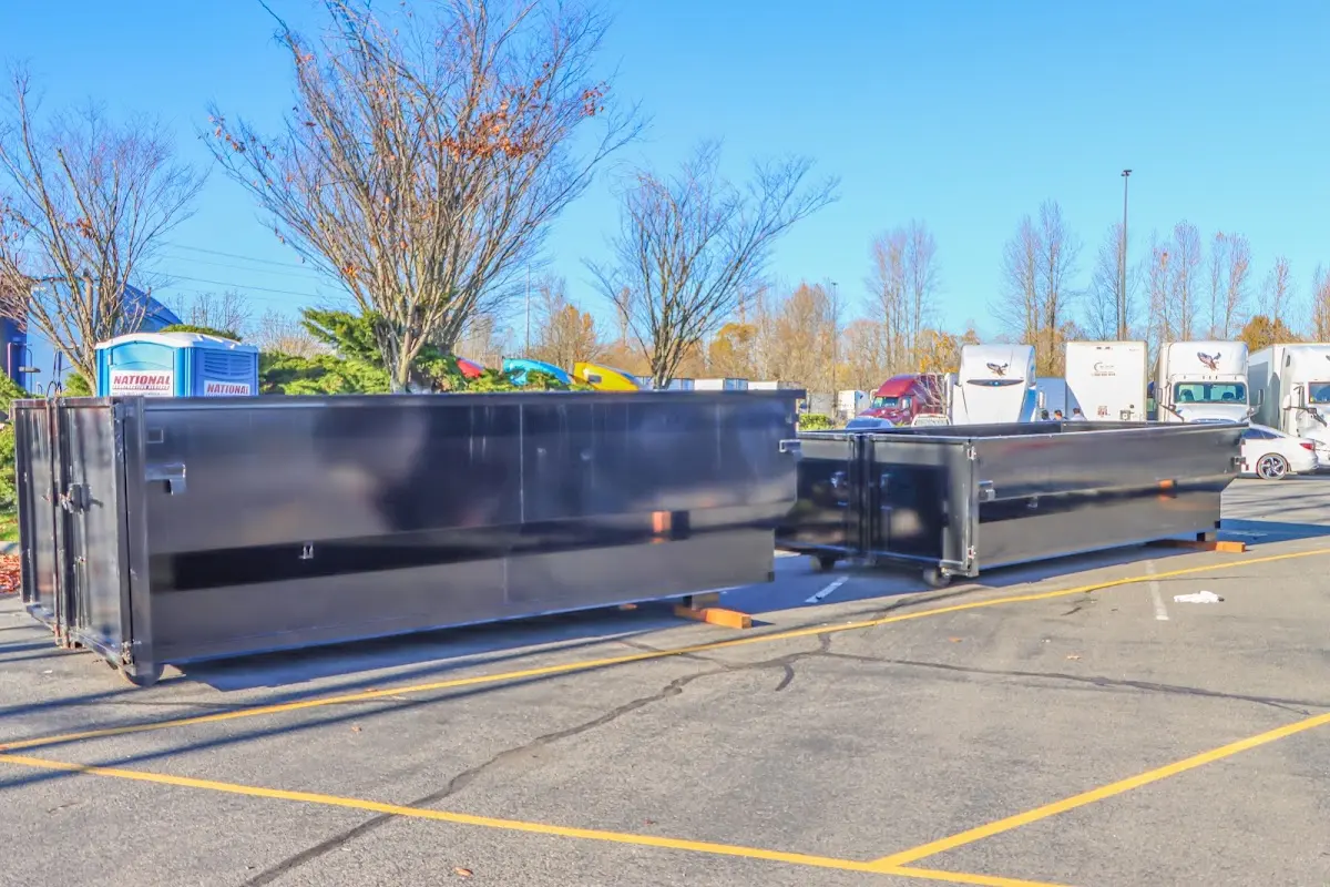 Professional dumpster rental service with roll-off container on residential driveway in Hibbing
